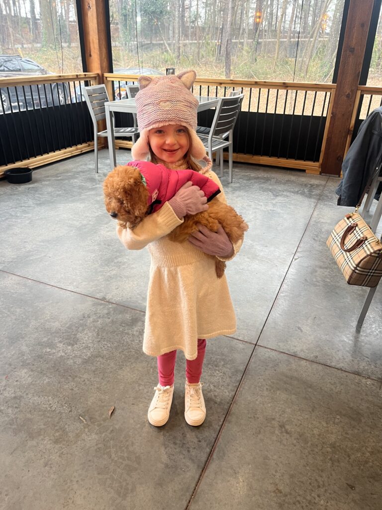 little girl and dog on patio